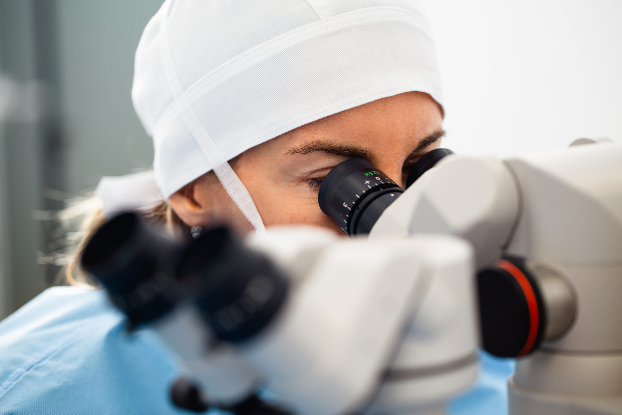 Doctor using microscope